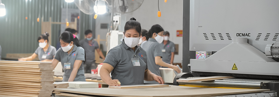 IMITI factory workers processing wooden furniture components